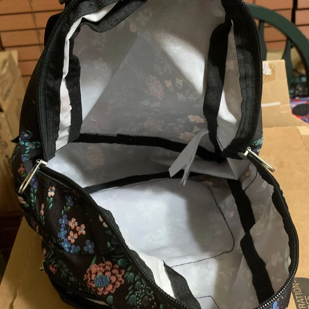 Jansport Black Mini Backpack with Pink, Purple & Green Floral Print.